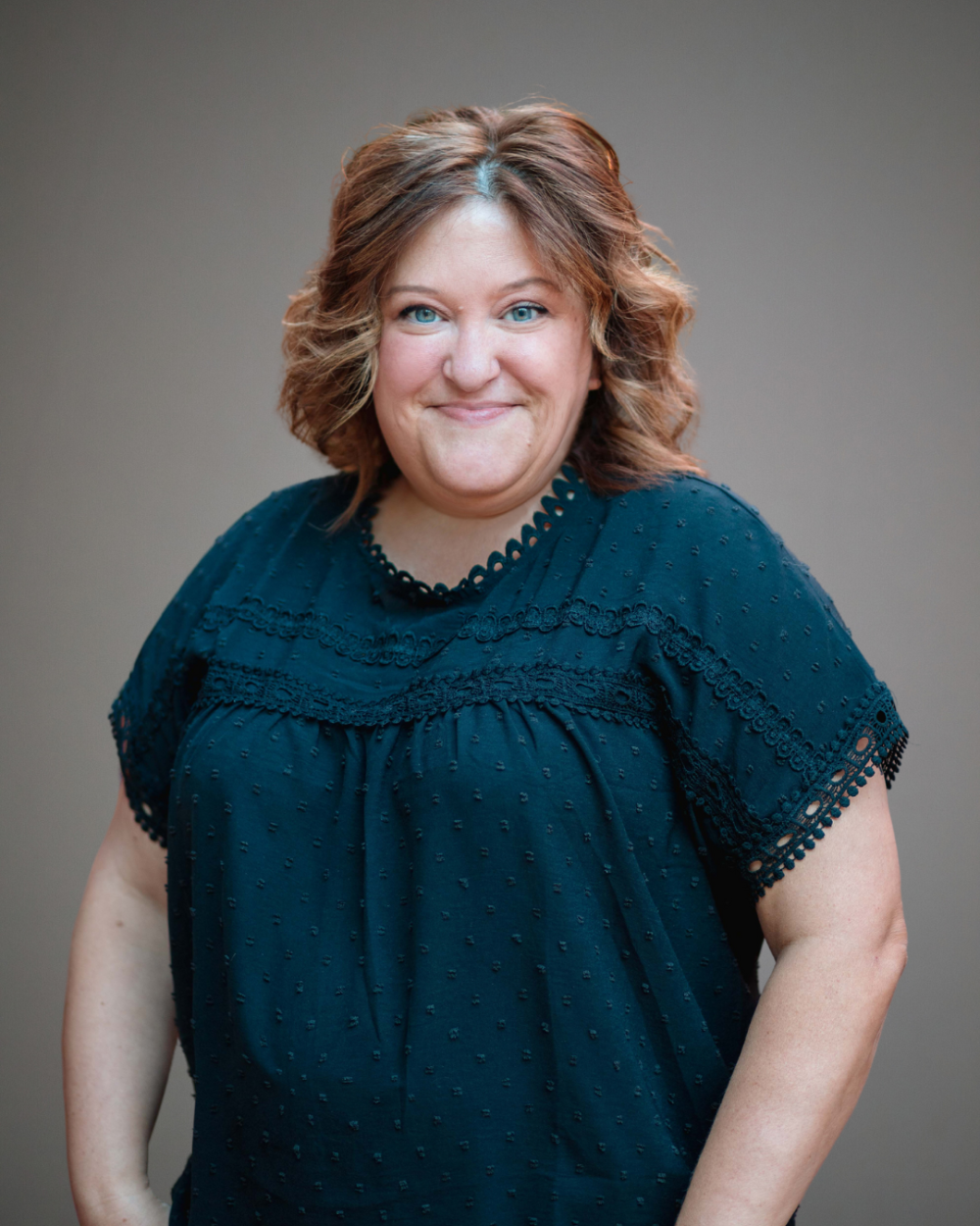 Heather has brown hair and wears a black blouse in her headshot for NDSS