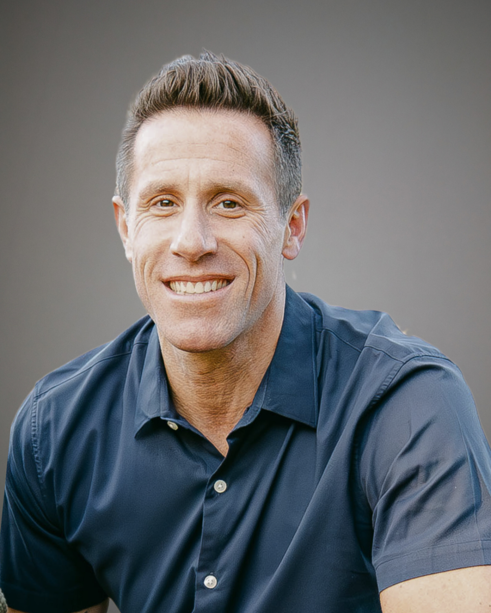 Headshort of Dan Vosnos, a man with brown hair, wearing a navy collared shirt